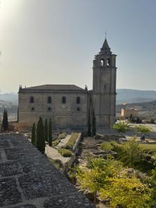 an old building with a clock tower on a hill at Alcalá zona Centro in Alcalá la Real