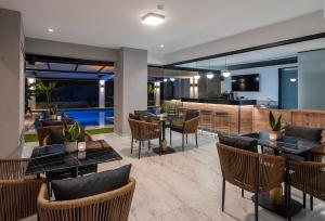 a restaurant with tables and chairs and a kitchen at Captain Napoleon Paterakis CNP Luxurious Suites in Heraklio