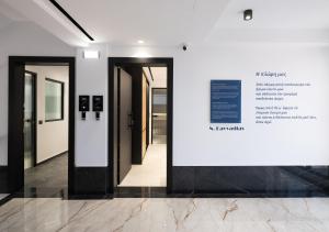 a group of doors in a hallway with a sign at Captain Napoleon Paterakis CNP Luxurious Suites in Heraklio +291 photos