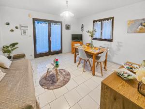 a living room with a table and a dining room at Maison paisible avec jardin à Houlgate in Houlgate