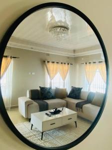 a living room with a couch and a table in a mirror at Family Home In Maun in Maun