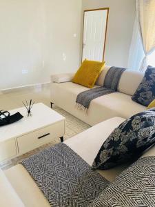 a living room with two couches and a table at Family Home In Maun in Maun
