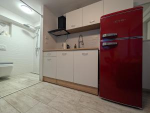 a kitchen with a red refrigerator in a room at Secluded Studio in Central Sesvete in Sesvete +26 photos