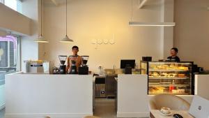 two people standing behind a counter in a bakery at Ratana Hotel Sakdidet, PHUKET TOWN in Phuket Town