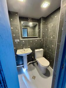 a bathroom with a toilet and a sink at Corner Guest House in Tbilisi City