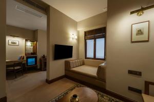 a living room with a couch and a television at Kashe Benaras in Varanasi