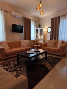 a living room with a couch and a coffee table at Maria’s apartment in Amfilochía