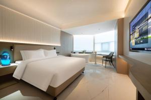 Postel nebo postele na pokoji v ubytování 沈阳财富凯莱酒店