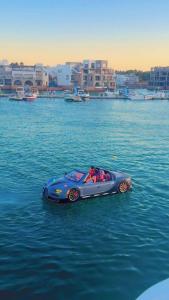 a toy car in the middle of the water at aqaba Almahdud in Aqaba