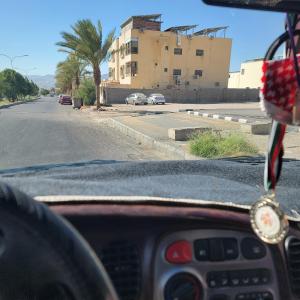 a view of a street from the inside of a car at aqaba Almahdud in Aqaba +2 photos