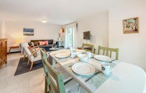 a dining room and living room with a table and chairs at 1 Bedroom Nice Apartment In De Panne in De Panne