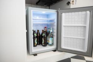 a refrigerator filled with lots of bottles of alcohol at Kaisercity Apartment 2 in Nuremberg