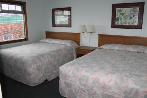 Postel nebo postele na pokoji v ubytování Azalea Lodge