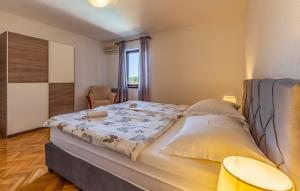 a bedroom with a bed and a chair and a window at House Ivica in Banjole +25 photos