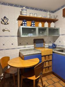 a kitchen with a table and chairs in a kitchen at Casa ARRUIZ in Riaza