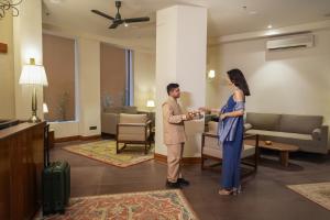 a man and a woman standing in a lobby at Kashe Benaras in Varanasi