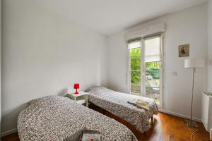 Ένα ή περισσότερα κρεβάτια σε δωμάτιο στο Cour de la Garonne -Proche Disneyland avec parking