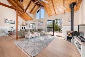 a living room with a couch and a fireplace at Holiday Retreat Jervis Bay - 5 Min Walk to Bay in Callala Bay