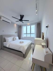 a white bedroom with a bed and a table at The Cotton Bleu Homestay in Kuala Terengganu +33 photos