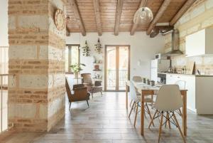a kitchen and dining room with a table and chairs at Holiday Home Camino Monferrato in Camino