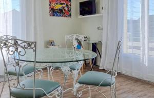 a dining room with a glass table and chairs at Charmante Maison À La Campagne in Chaintrix-Bierges