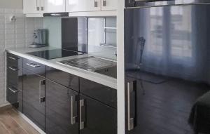 a kitchen with white cabinets and a stove top oven at Charmante Maison À La Campagne in Chaintrix-Bierges