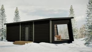 une cabane dans la neige avec une chaise à l'intérieur dans l'établissement Raitola Reindeer and Husky Farm- Panorama Lodges, à Rovaniemi