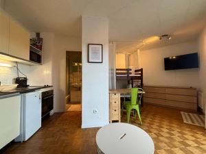 a kitchen and living room with a table and chairs at Studio lumineux - Les Angles in Les Angles