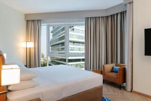 a hotel room with a bed and a large window at Four Points by Sheraton Bur Dubai in Dubai