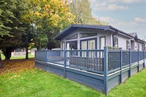 a blue fence in front of a house at Sunbird Lodge with Hot Tub in York