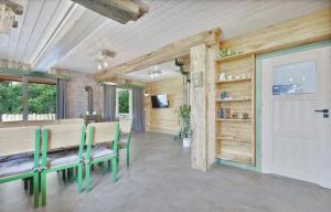 a dining room with a table and chairs and a door at Gabrysiówka in Sztabin