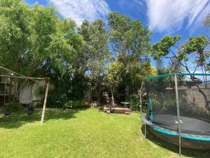 a playground with a trampoline in a yard at Lovely Family Home in Durbanville in Durbanville +57 photos