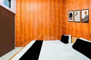 a bedroom with a bed with a wooden wall at Hotel pushpanjali in Haldwāni