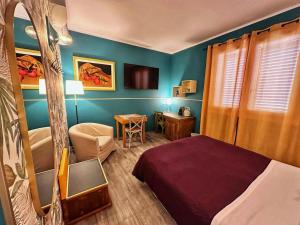a bedroom with blue walls and a bed and a chair at AlCivico3 in Civitanova Marche