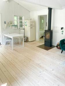 a kitchen with a white table and a stove at Holiday Home By Nyrup Bay And Rørvig Harbour in Rørvig