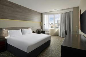 a hotel room with a bed and a desk at Four Points by Sheraton Perth in Perth