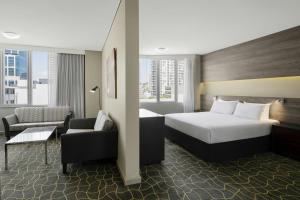 a hotel room with a bed and a chair at Four Points by Sheraton Perth in Perth +58 photos