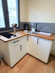 a kitchen with white cabinets and a sink at TABLERO 101, coqueto y moderno estudio in El Tablero +12 photos