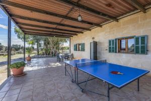 a blue ping pong table on a patio at Mercedes in Santa Margalida