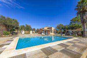 a swimming pool in a yard with a house at Mercedes in Santa Margalida