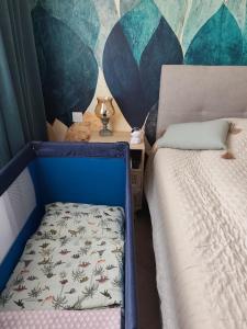 a small bedroom with a bed and a wall at Light Blue Apartment Orihuela Costa in Orihuela Costa +34 photos