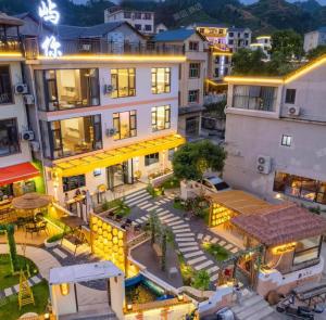 an aerial view of a building in a city at night at Yu Ni Meisu-wang xian gu Branch in Qiaotou