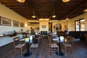 a dining room with tables and chairs in a restaurant at Sarzana-Charming Apartment Pool and BB in Sarzana