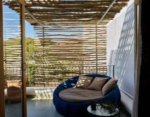 a large blue couch sitting on a balcony at Gare du Nord in Sant Joan de Labritja