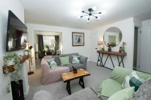 a living room with a couch and a table at Stylish 3 Bed Retreat, Parking, Great Location Newport in Newport
