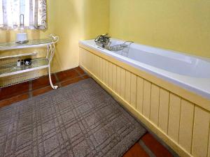 a bathroom with a bath tub and a sink at Villa Rosa in Ladismith