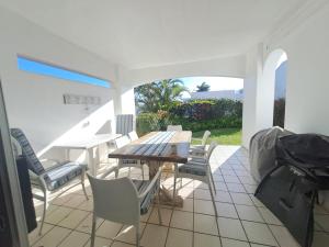 a patio with a wooden table and chairs at Easy Breezy at 18 Thira Santorini in Ballito