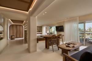 a living room with a bed and a dining room at Aya Resort - Adults Only in Ayia Napa