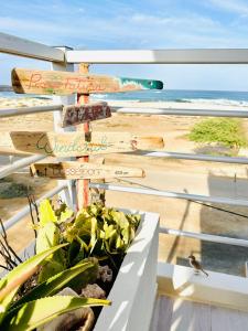 a planter with signs in front of a beach at Ocean Breeze 9 in Sal Rei