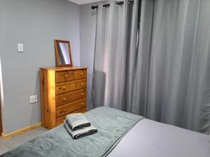 a bedroom with a bed and a dresser and a window at Aqua Farm - Family Unit in Teba